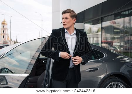 Come In Time! Handsome Serious Young Entrepreneur Buttoning His Understated Jacket, While Going Out 