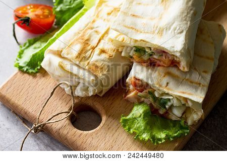 Shaurma, Cut In Half, Shaurma Doner, Meat With Vegetables In A Bread Cake, On A Light Stone Or Concr