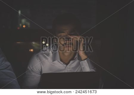 Business Overtime Concepts . Group Of Business People Working Overtime In Nighttime. Businessmen Are