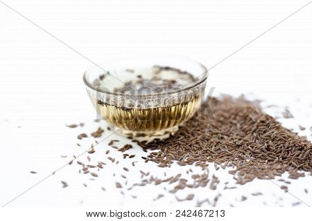 Common Cumin Or Zeera Or Jeera In A Bowl Isolated On White With Its Extracted Water In A Bowl.;
