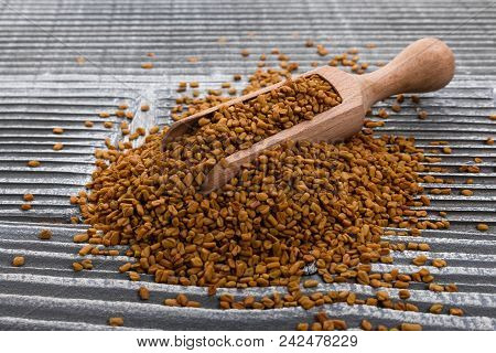 Fragrant Grains Of Fenugreek On A Rustic Background.