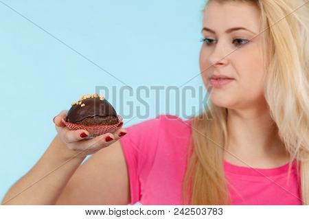 Diet, Sweets, Food Concept. Woman Holding Delicious Chocolate Cupcake With Peanut Frosting About To 