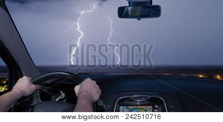 Driving A Car Towards A Spectacular Lightning Storm Over The Sea