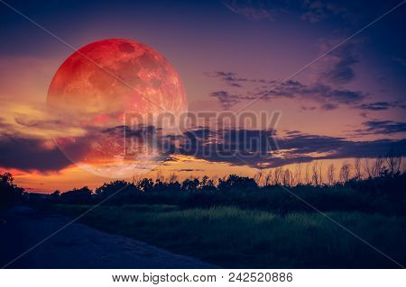 Beautiful Countryside Area At Night. Attractive Red Super Moon Or Blood Moon On Dark Sky With Cloudy