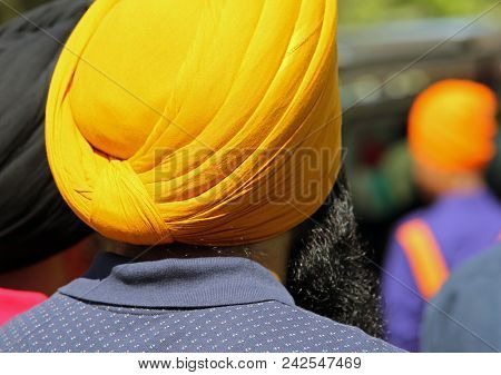 Sikh Man With Yellow Turbant Called Dumalla During A Religious Celebration On The Streets Of The Cit