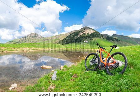 Mountain Ebike Stops Near An Alpine Lake In Spring.