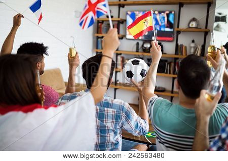 Happy Friends With Drinks Watching Soccer Game On Tv At Home And Celebrating Victory