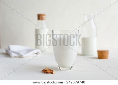 Some Fresh Milk In Glass Bottles And Decorated With Kitchen Napkin And A Box-keeper.