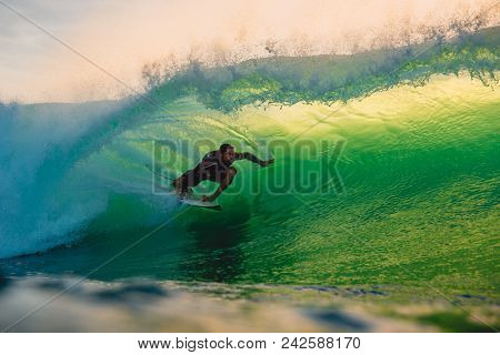 April 23, 2018. Bali, Indonesia. Surfer Ride On Big Barrel Wave At Padang Padang. Professional Surfi