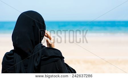 Muslim Woman On The Sunny Beach Back View