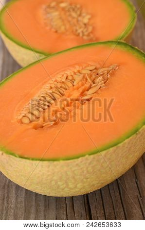Ripe Organic Cantaloupe Melon (muskmelon, Mushmelon, Rockmelon) Cut In Half On Old Wooden Table.sele