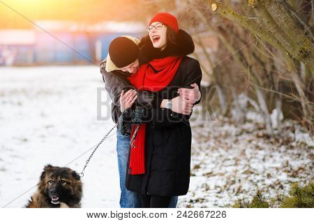 Happy Couple With Dogs In Winter Forest. Lovely Moments Outdoor