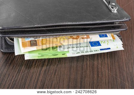 Open Wallet With Euro Cash 10 20 50 100 On A Wooden Background. Men's Wallet With Cash Euro.
