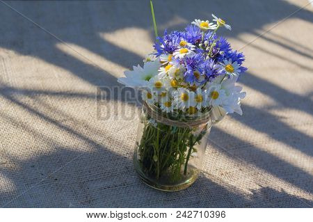 Wild Flowers In A Glass Jar. Decoration
