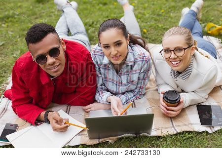 Students In Denim. Three Stylish Students Wearing Fashionable Denim Feelin Amazing While Lying In Th