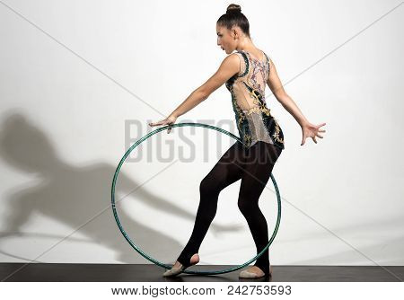 Full Length Of Young Pretty Girl Playing Hoola Hoop On White Background