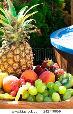 Mix Of Different Exotic Fresh Colorful Fruits On Dark Wooden Table And Green Trees. Relax Conceprion