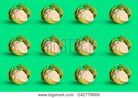 Colorful Pattern Of Young Cauliflower On A Green Background. Concept Of Healthy Food. Natural Organi