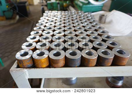 Cylindrical Metal Parts Are Located On The Rack After Turning.