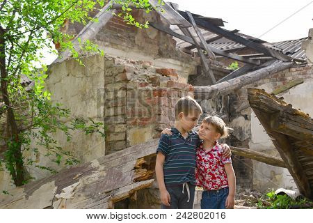 Poor And Neschatnye Children On The Ruins Of A Burnt House. The Brothers Suffered A Natural Disaster