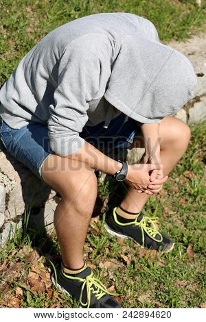 Depressed Boy With Gray Sweatshirt And Hood On Head