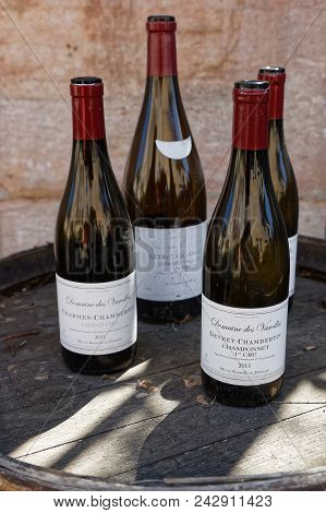 Gevrey-chambertin, France, May 21, 2018 : Bottles Of Wine On A Barrel In Gevrey-chambertin, A Touris