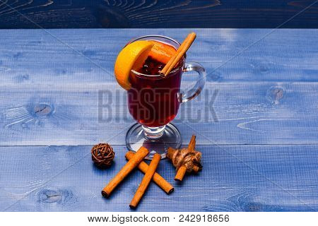 Drink Or Beverage With Orange And Cinnamon. Glass With Mulled Wine Or Hot Cider Near Cinnamon Sticks