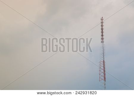 Radio Telecommunications Tower, Cell Site, Mobile Phone Tower And Old Steel Pipe In Cloud. Flare Con