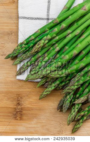 Fresh Green Asparagus On Linel Napkin And Wood Table.
