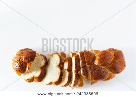 Cut Braided Bread Sprinkled With Poppy Seeds, Isolated On White.