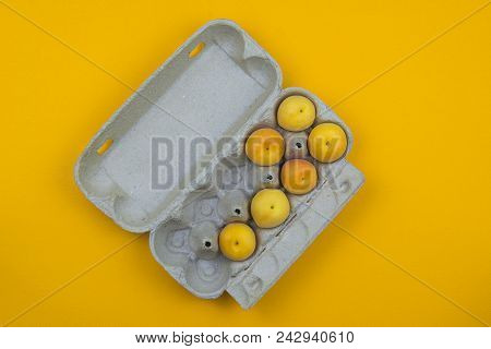 Apricots Are In The Egg Box On A Yellow Background. Summer