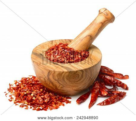 Dried Red Chilli Flakes In The Wooden Mortar, Isolated On White Background