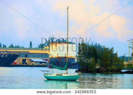 May 16, 2018 In Hilo, Hi:  Industrial Port And A Sail Boat Anchored In Hilo Hi Where People Can Anch