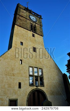 An Exterior View Of A Church Building With Clock Tower In Anstruther
