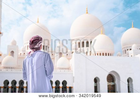 Arab Man Visiting The Grand Mosque In Abu Dhabi Wearing Traditional Dress Back View