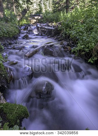 Creek Flowing In The Colorado Rocky Mountains.