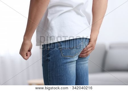Man Suffering From Hemorrhoid At Home, Closeup