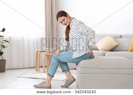 Young Woman Suffering From Hemorrhoid At Home