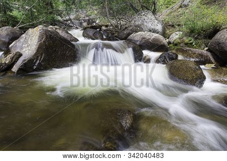 Colorado Flowing Creek High In The Rocky Mountains.