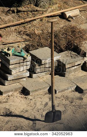 Pavior At Work: Stacked Tiles In The Sand