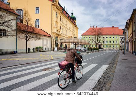 Woman On Bicycle At National Hall In Celje In Slovenia