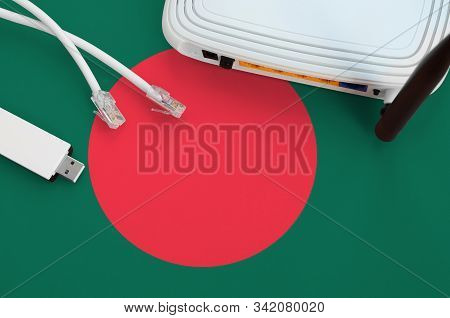 Bangladesh Flag Depicted On Table With Internet Rj45 Cable, Wireless Usb Wifi Adapter And Router. In