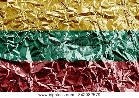Lithuania Flag Depicted In Paint Colors On Shiny Crumpled Aluminium Foil Closeup. Textured Banner On