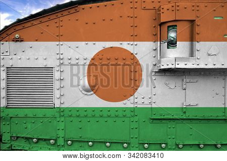 Niger Flag Depicted On Side Part Of Military Armored Tank Closeup. Army Forces Conceptual Background