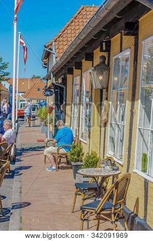 Svaneke, Bornholm, Denmark - June 2018. Sitting In Front Of A Cafe And Enjoying The Warm Summer Weat
