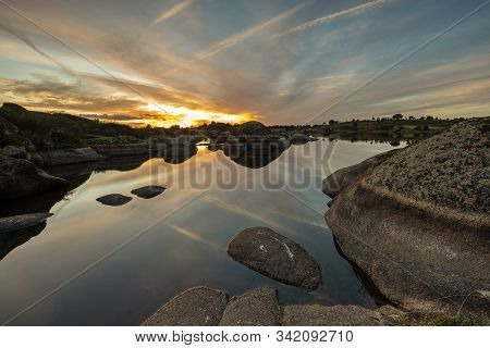 Sunset In The Natural Area Of The Barruecos. Extremadura. Spain.
