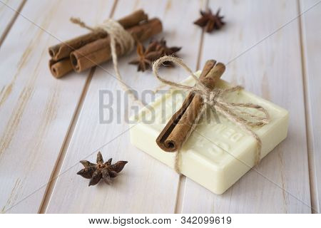 Organic Soap With Cinnamon On Wooden Table