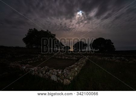 Night Landscape With Roman Ruins. Ancient Roman Villa Of Los Terminos In Monroy. Extremadura. Spain.