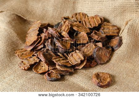 Dried Bull Testis. Sliced In Circles, Natural Goodies On Burlap. Close-up. Selective Focus.
