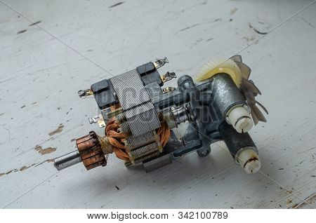 Faulty Motor In Used Kitchen Mixer. Engine Assembly On A Light Wooden Table. Service And Repair Of H